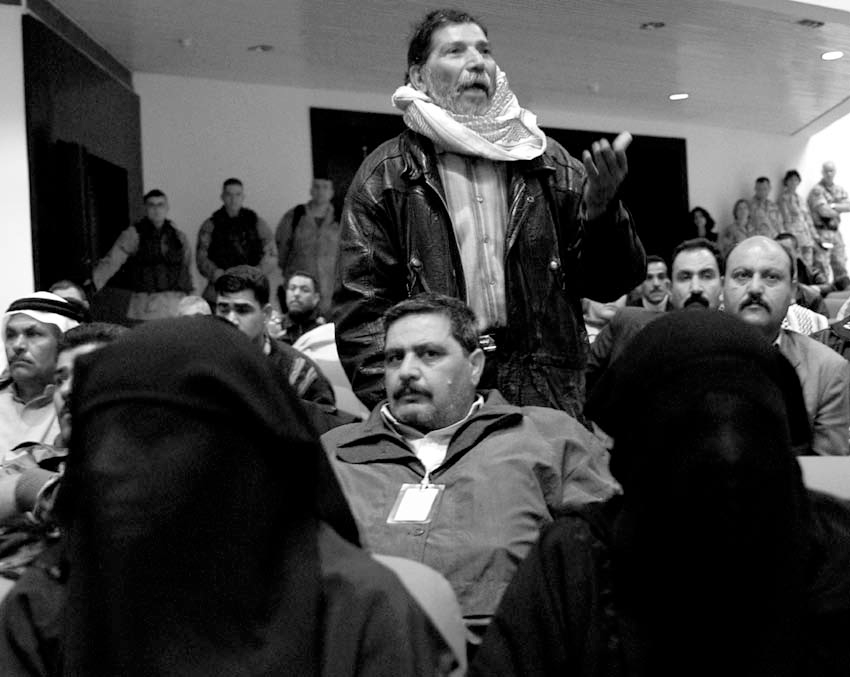During a recognition ceremony held in the Baghdad Convention Center on 9 January 2004, an Iraqi working for the Civil Defense Corps petitions the Coalition for compensation for all the wounded Iraqis and widows.